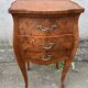 Pair of bedside tables with bombé shape, marquetry, and bronze in Louis XV style.