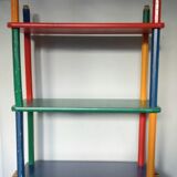 Shelf on legs, library, crayons in 4 colours.