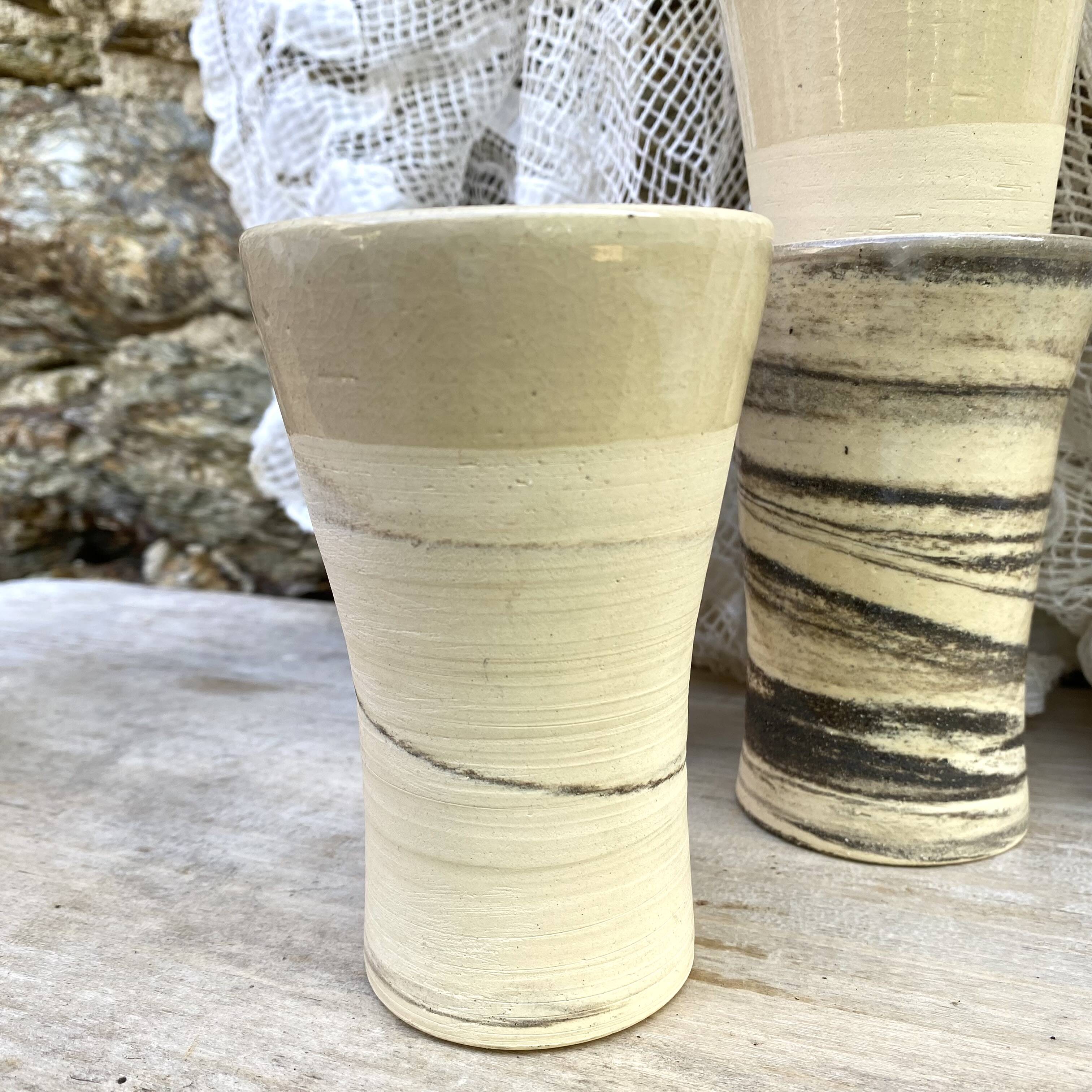 High ceramic cups made of mixed clay.