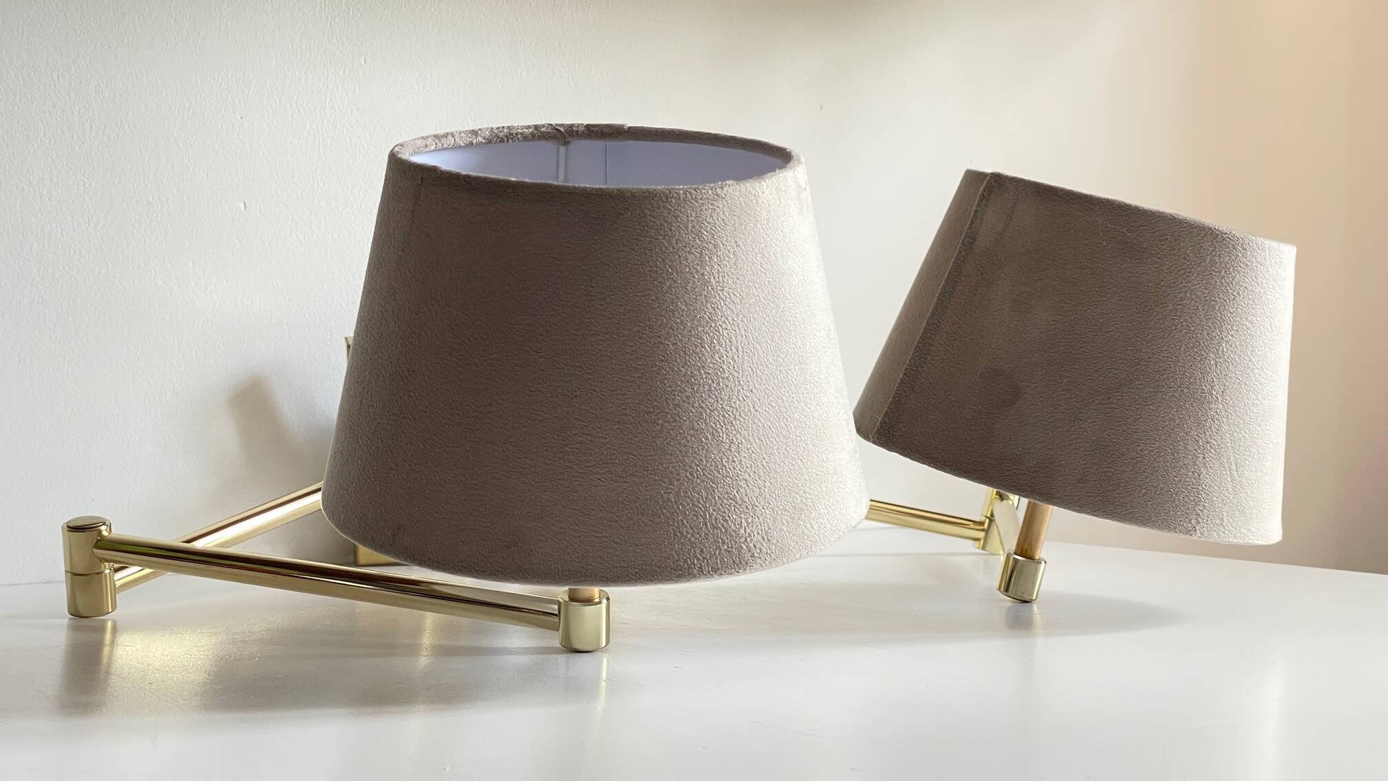 articulated brass and velvet wall light