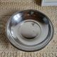 Shallow round metal plate with pearl row decoration.