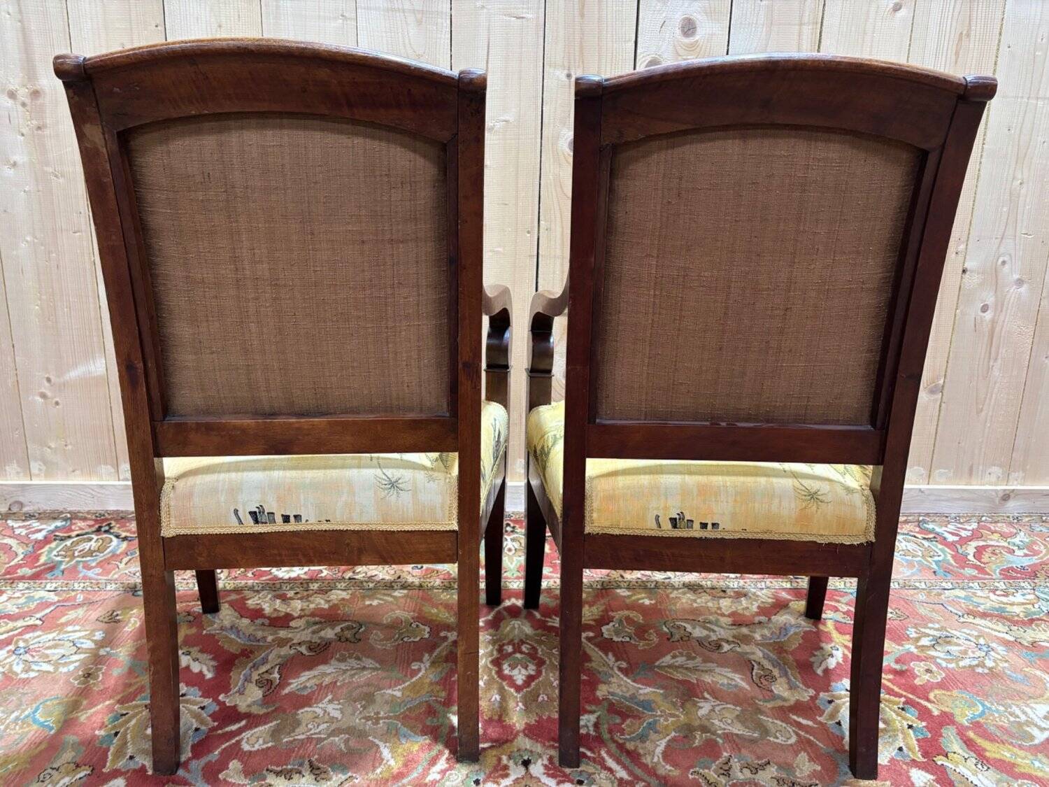 Pair of 19th-century armchairs with a scrolled back