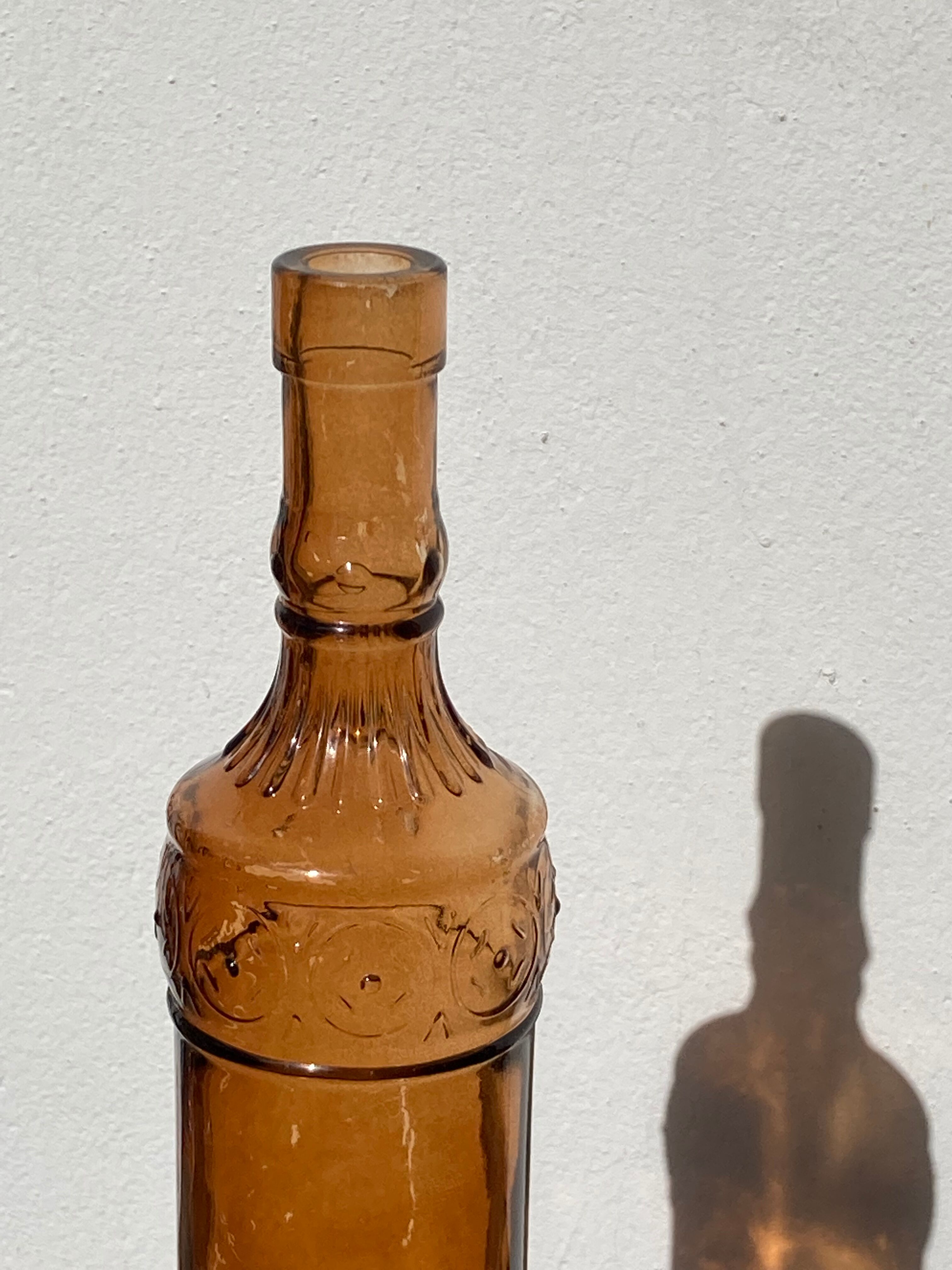 Vintage amber bottle in patterned brown glass