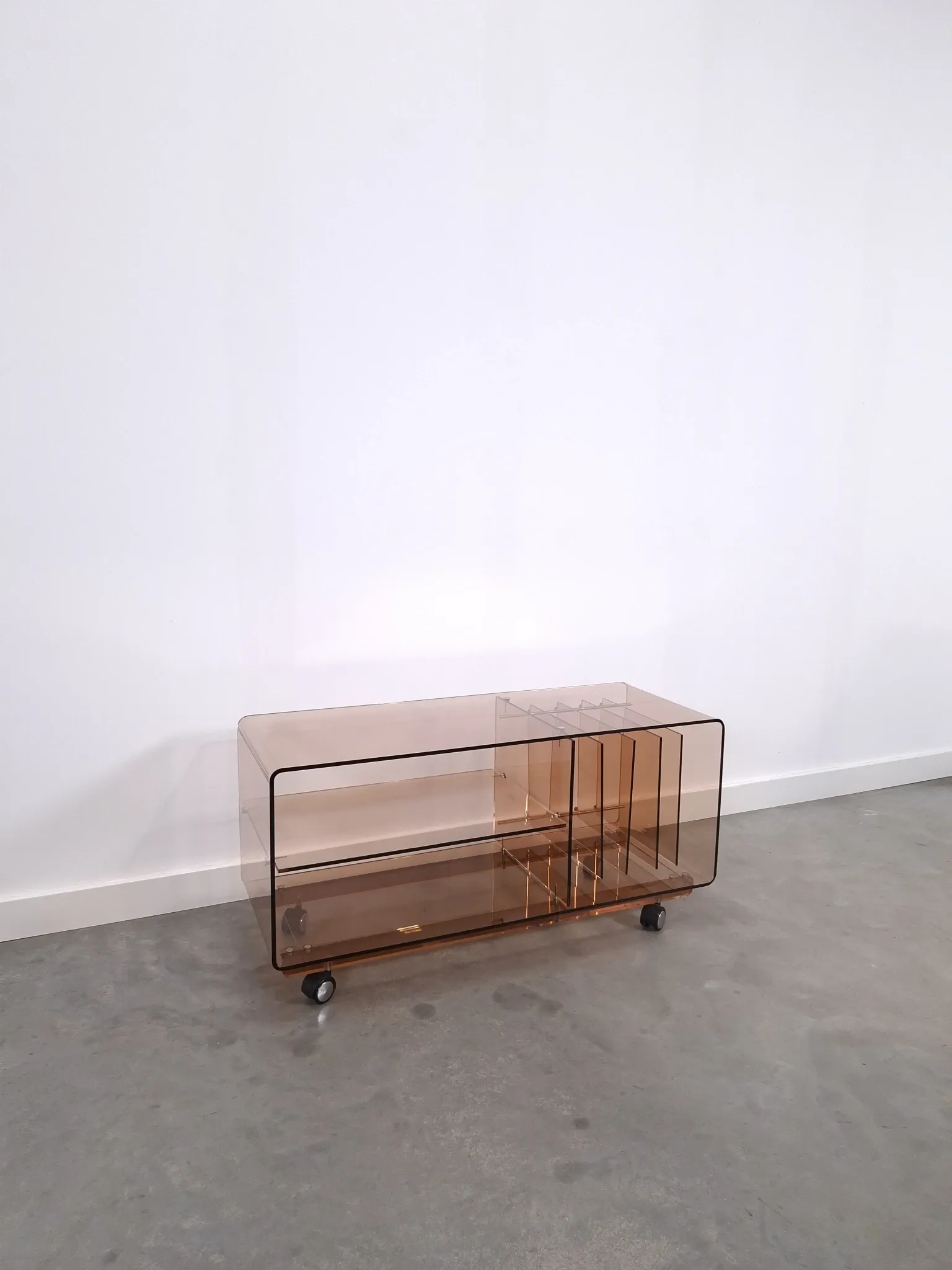 Vintage hifi, LP cabinet, TV unit made of tinted plexiglass on wheels, records.
