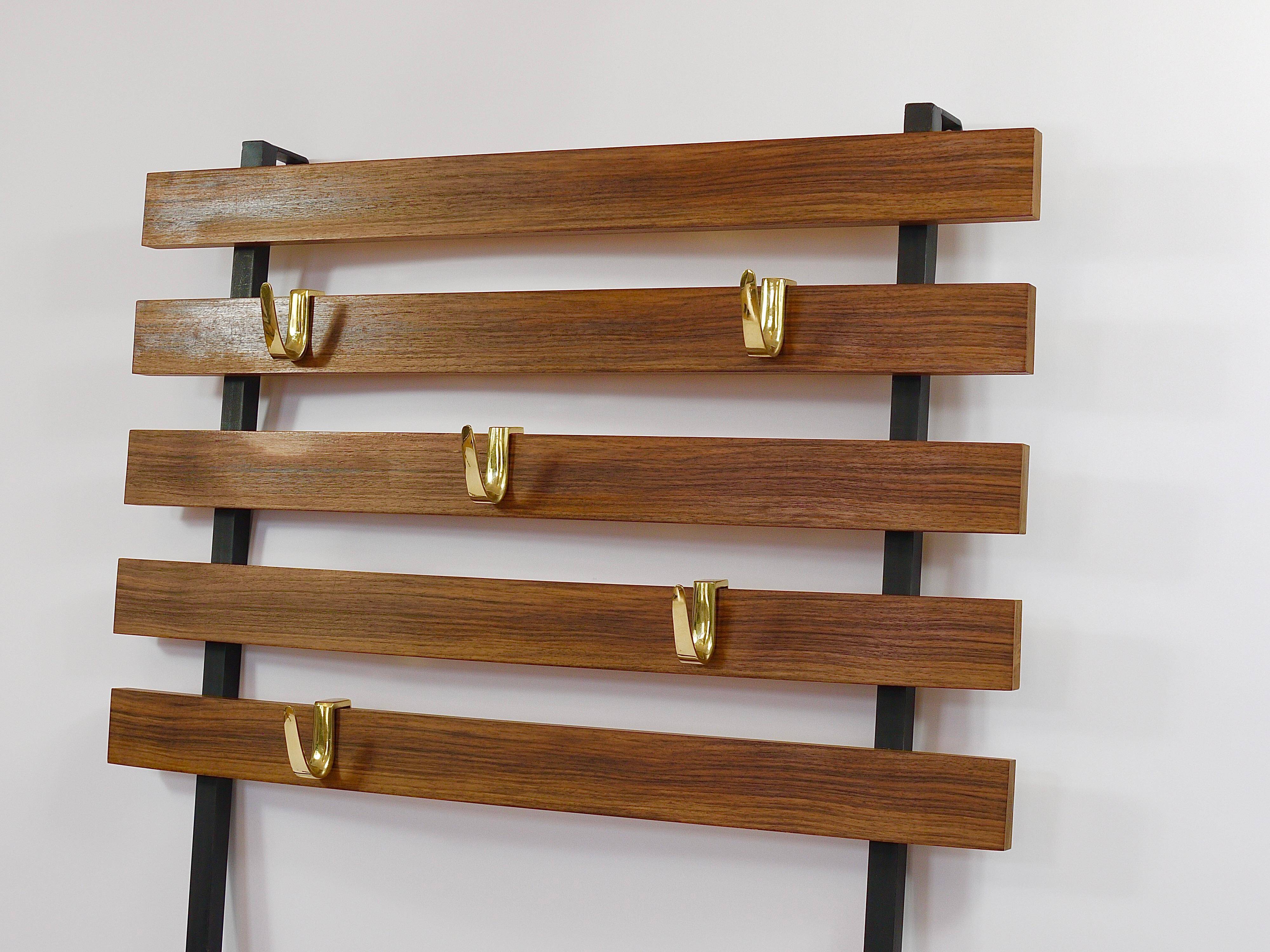 Wall coat rack by Carl Aubock with 5 brass hooks, walnut, iron, Austria, 1950s.