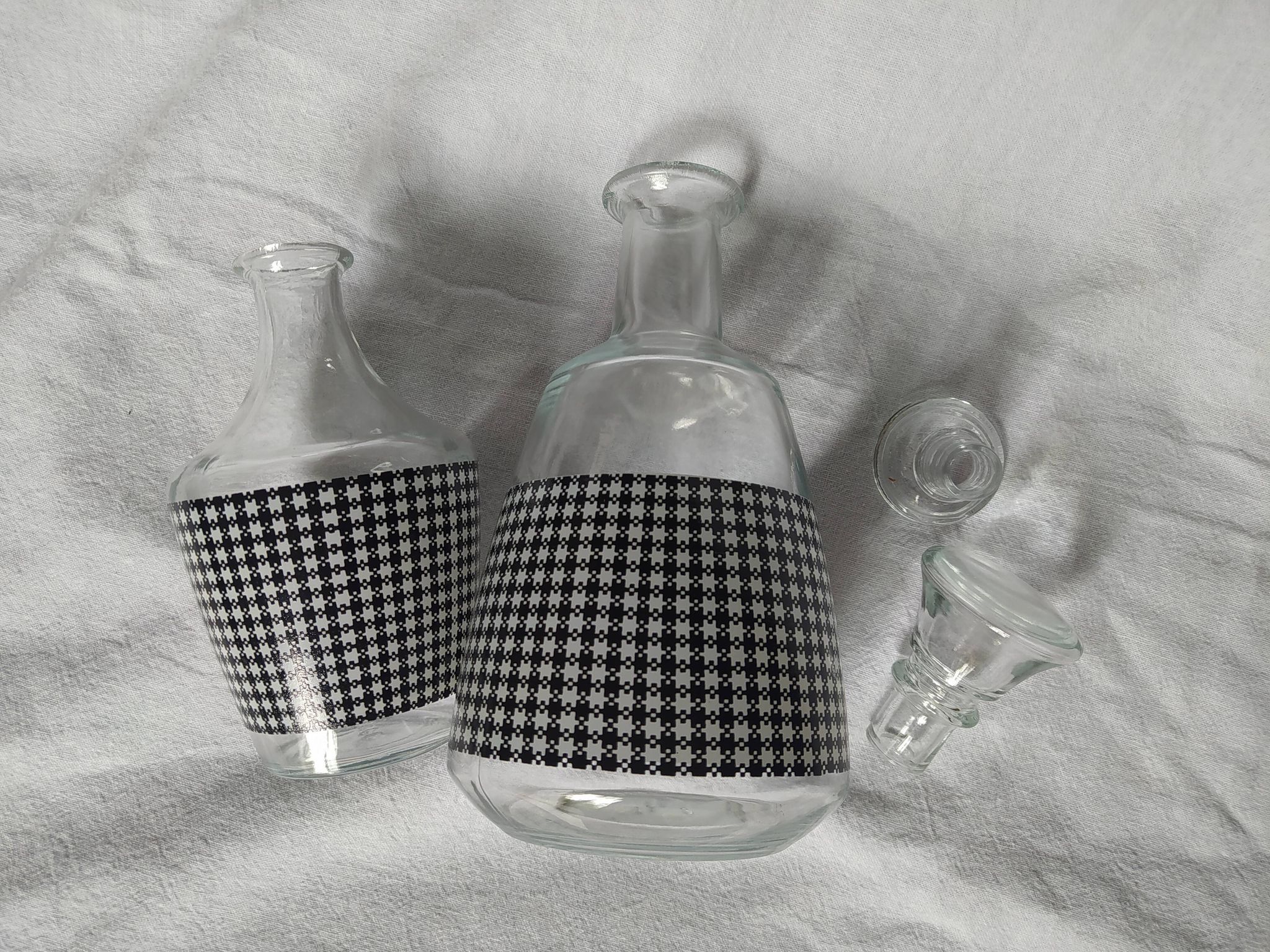 Set of 2 black and white houndstooth glass carafes from the Arques crystal factory. Rare.
