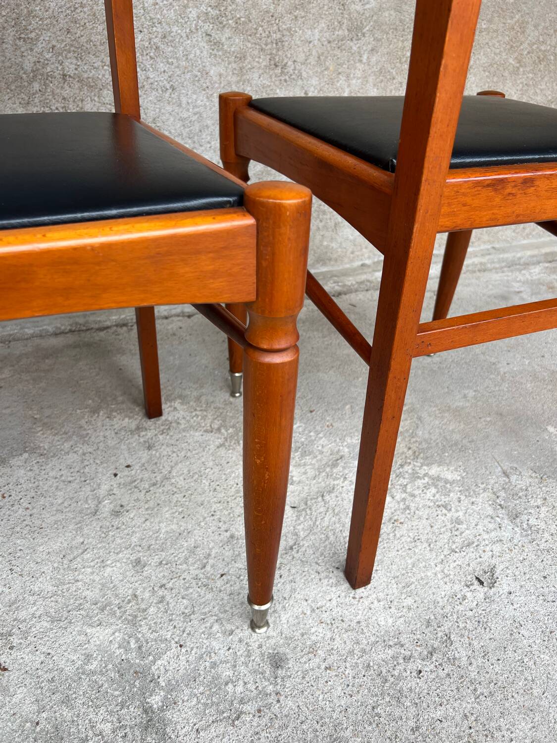 2 wooden and faux leather chairs in Scandinavian style