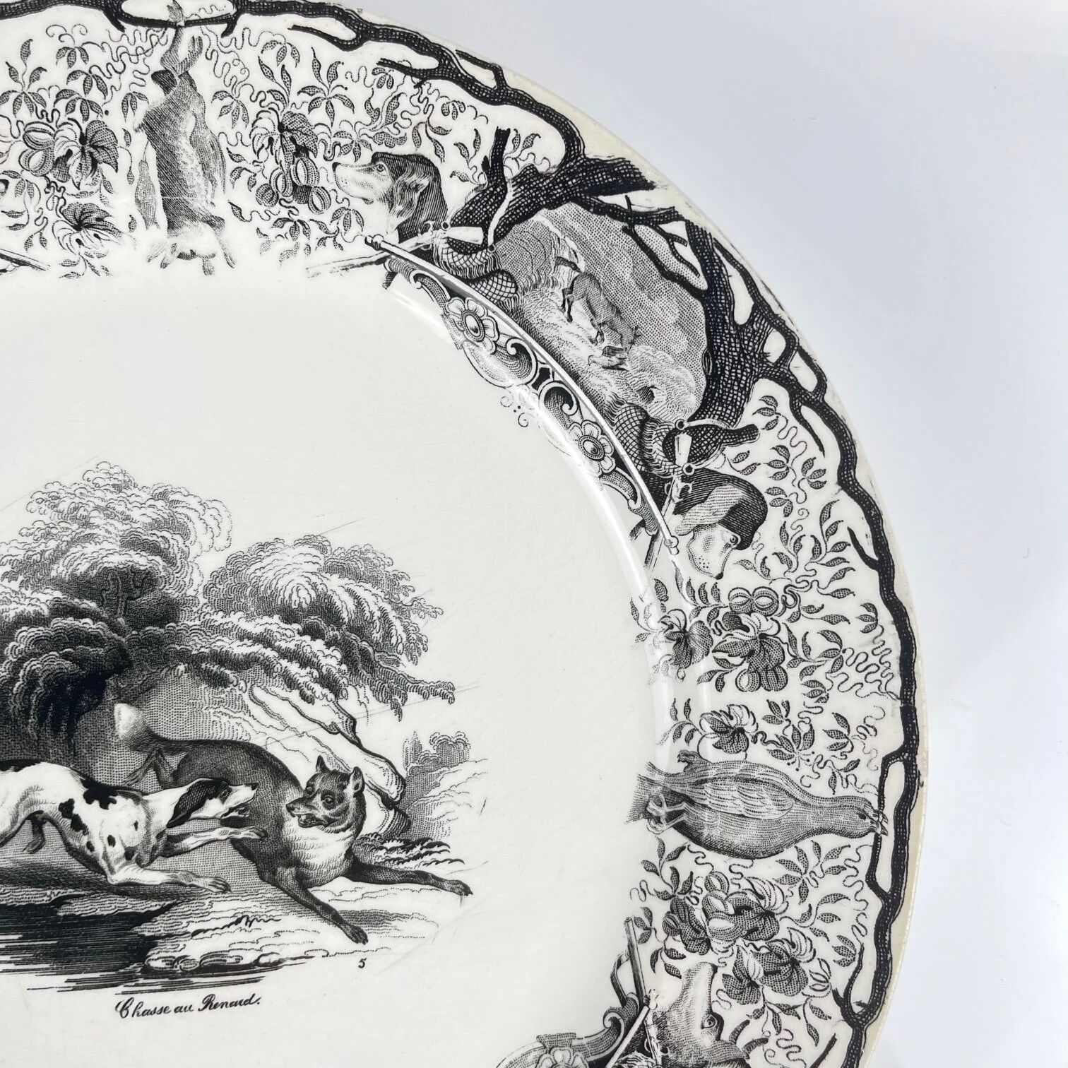 Set of three antique Sarreguemines U&C plates with hunting decoration from 1850 - 19th century black earthenware featuring a doe, chamois, and fox.