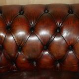 Pair of restored antique Chesterfield sofas in Boudreaux leather.