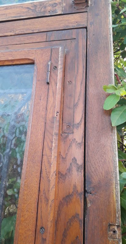 Oak entrance door and its frame and transom, wrought iron gates