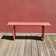 Banc ancien en bois peint en rouge