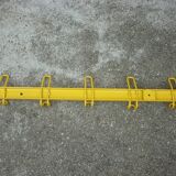 Yellow metal wall coat holder