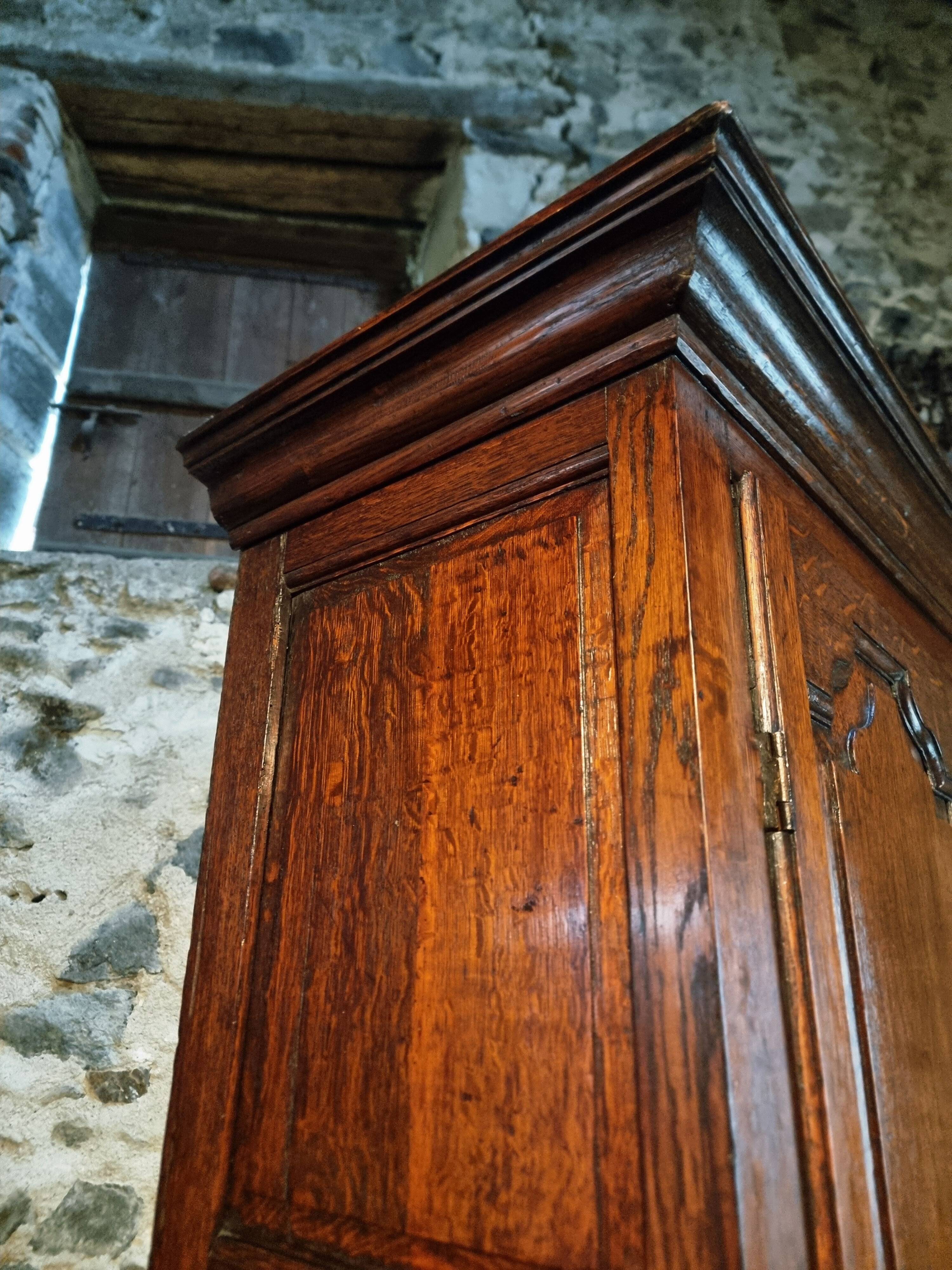 Antique English oak wardrobe with drawers, England, circa 1800–1820.
