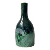 Ceramic vase with a glazed blue/green finish.