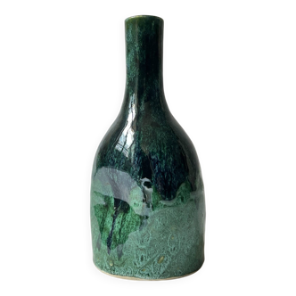 Ceramic vase with a glazed blue/green finish.