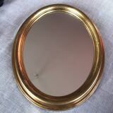 Golden oval mirror