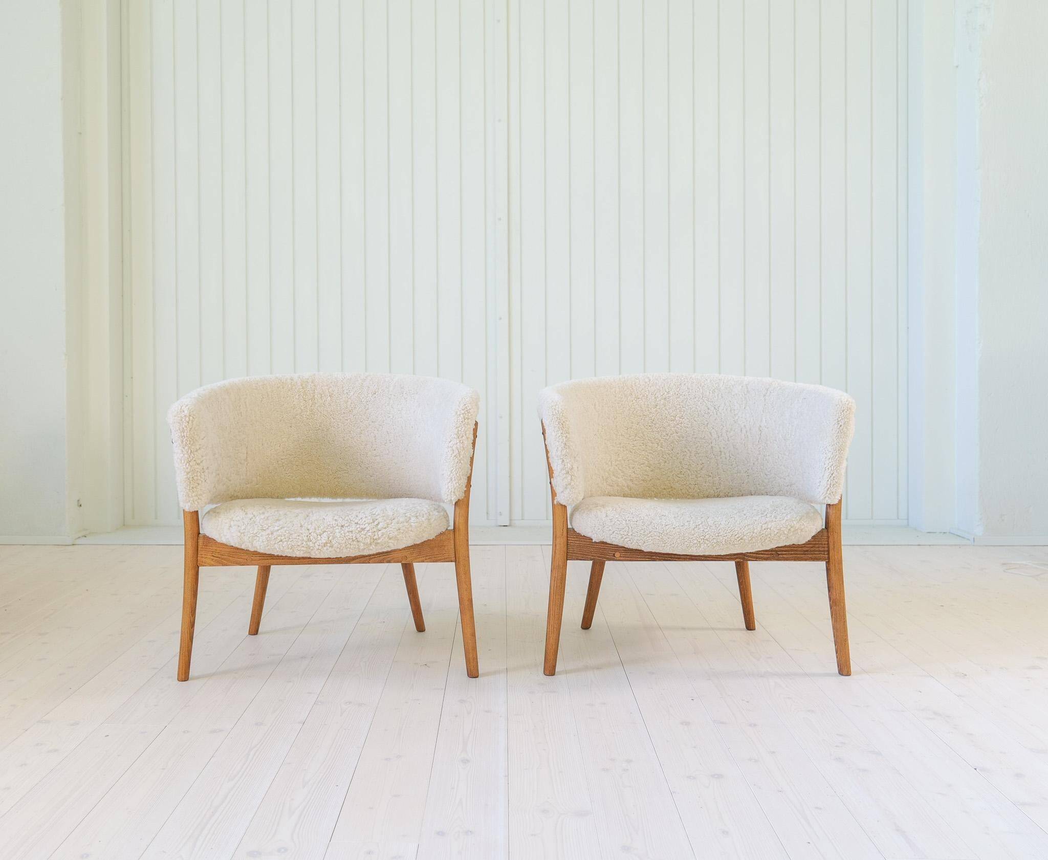 Mid-century lounge chairs in sheepskin/shearling and stained wood, Sweden, 1962.