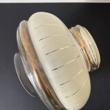 Glass globe with vanilla-colored striped patterns and gold edging