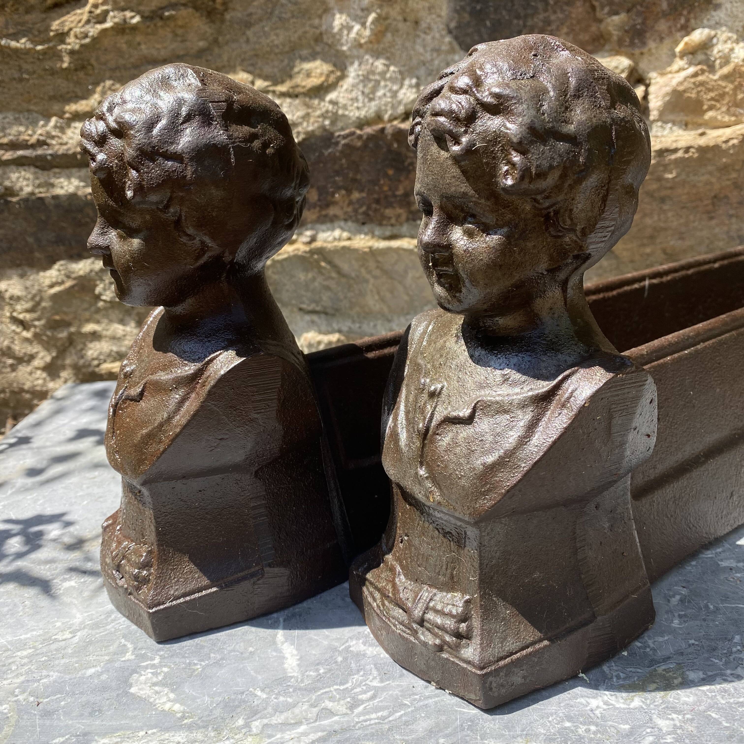 Pair of antique cast iron fire dogs "The Conquering Love"