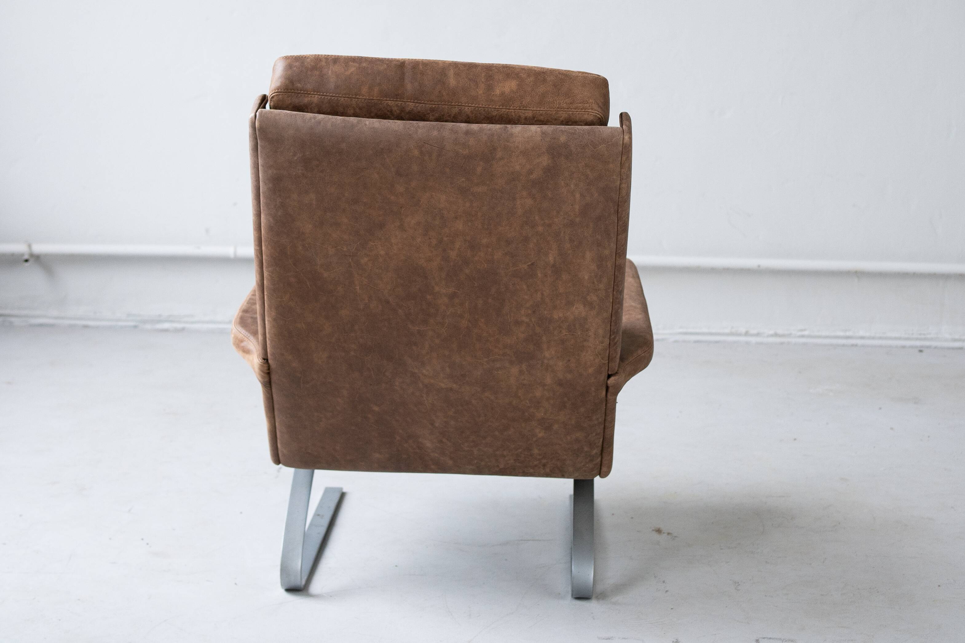 Vintage swing armchair and stool in leather by reinhold adolf for cor, 1970s, set of 2