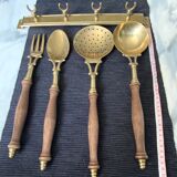 Old kitchen utensils in brass and wood.