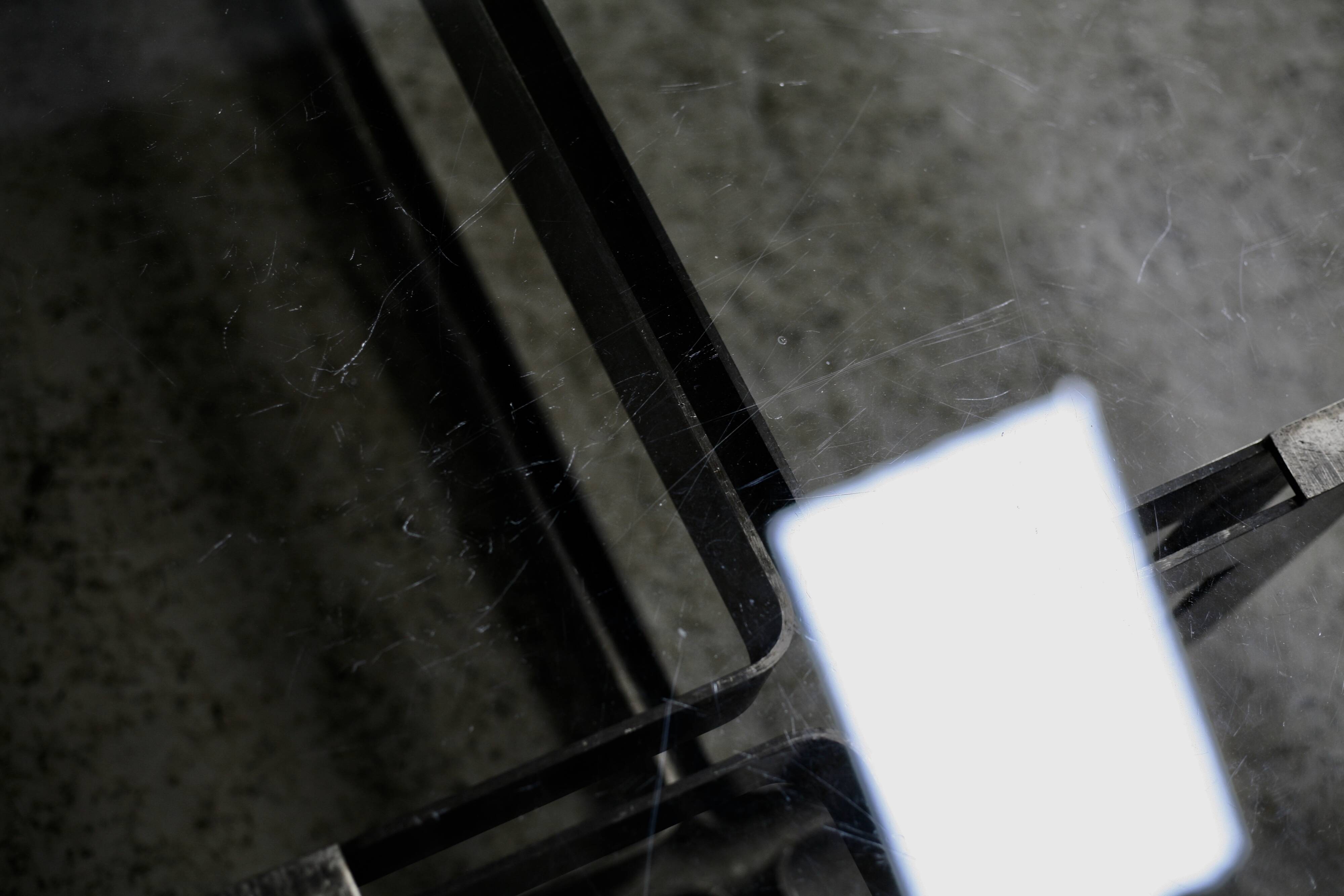 Coffee table with steel base and smoked glass slab. Circa 197