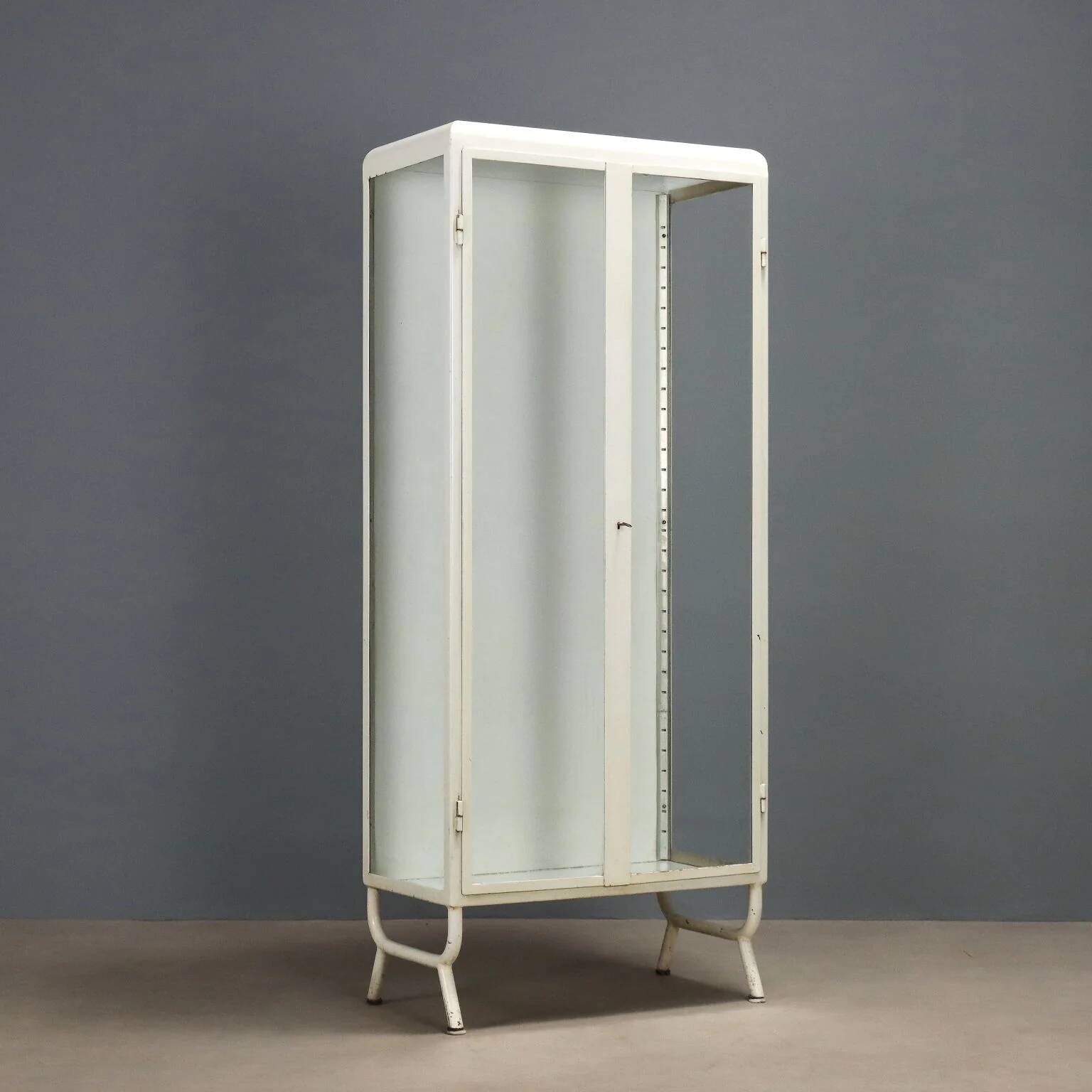 Antique enamelled iron and glass display cabinet, Italy, 20th century