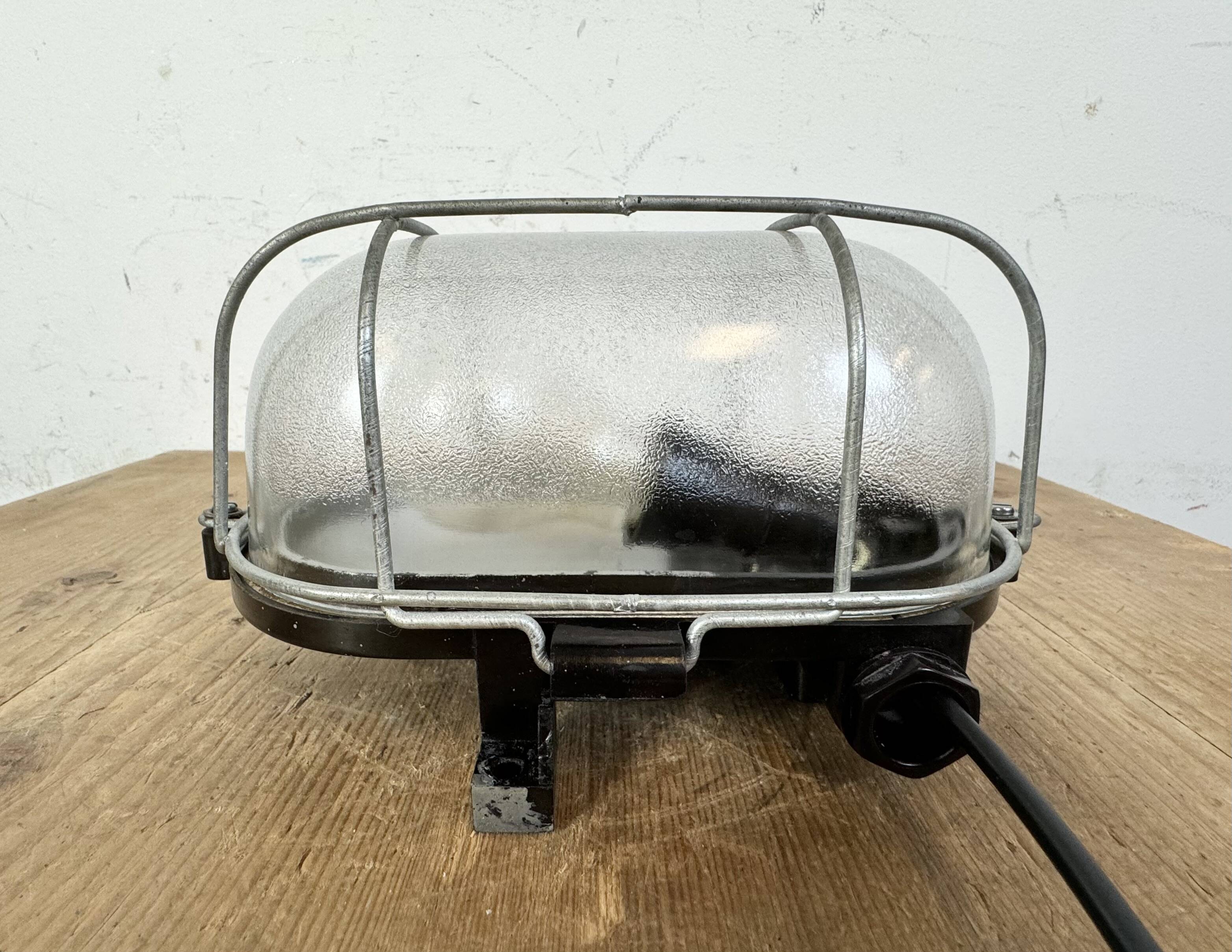 Industrial brown bakelite wall light with frosted glass, 1960s