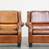 Set of 2 very comfortable large sheepskin armchairs elegantly finished with black piping