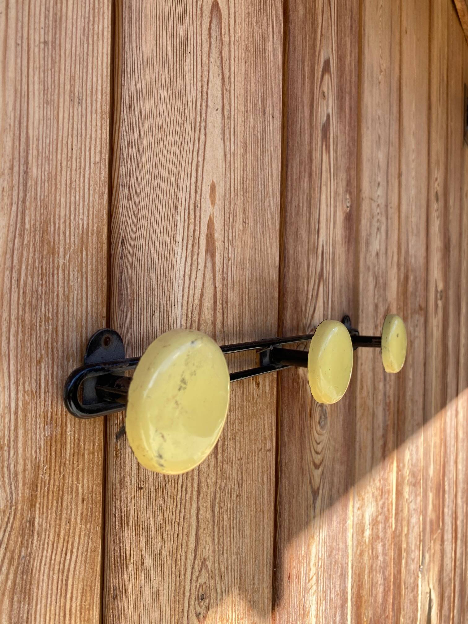 Vintage yellow metal wall coat rack