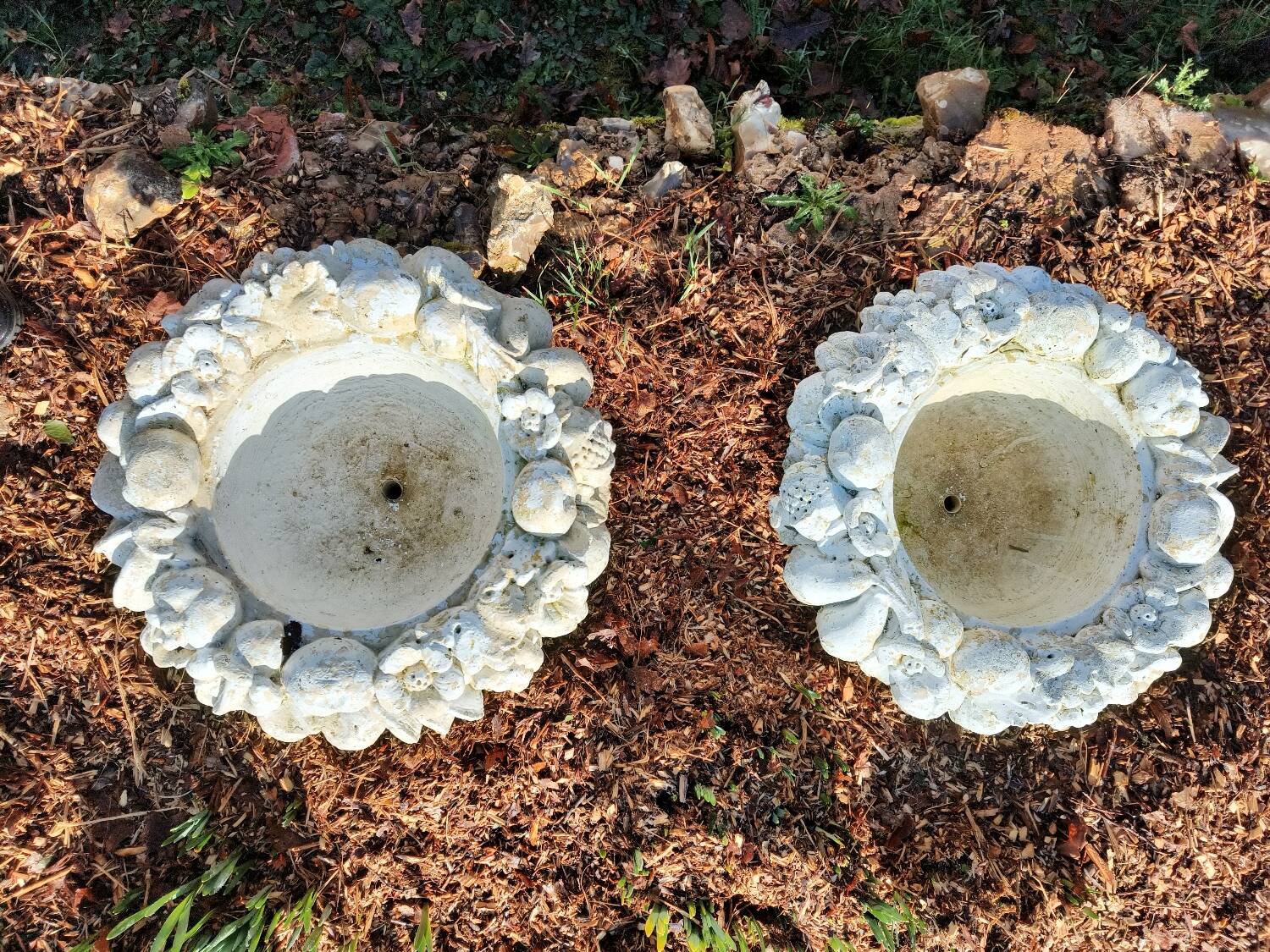 Pair of round stone fruit bowls on foot