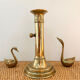 Old brass candlestick with push button.