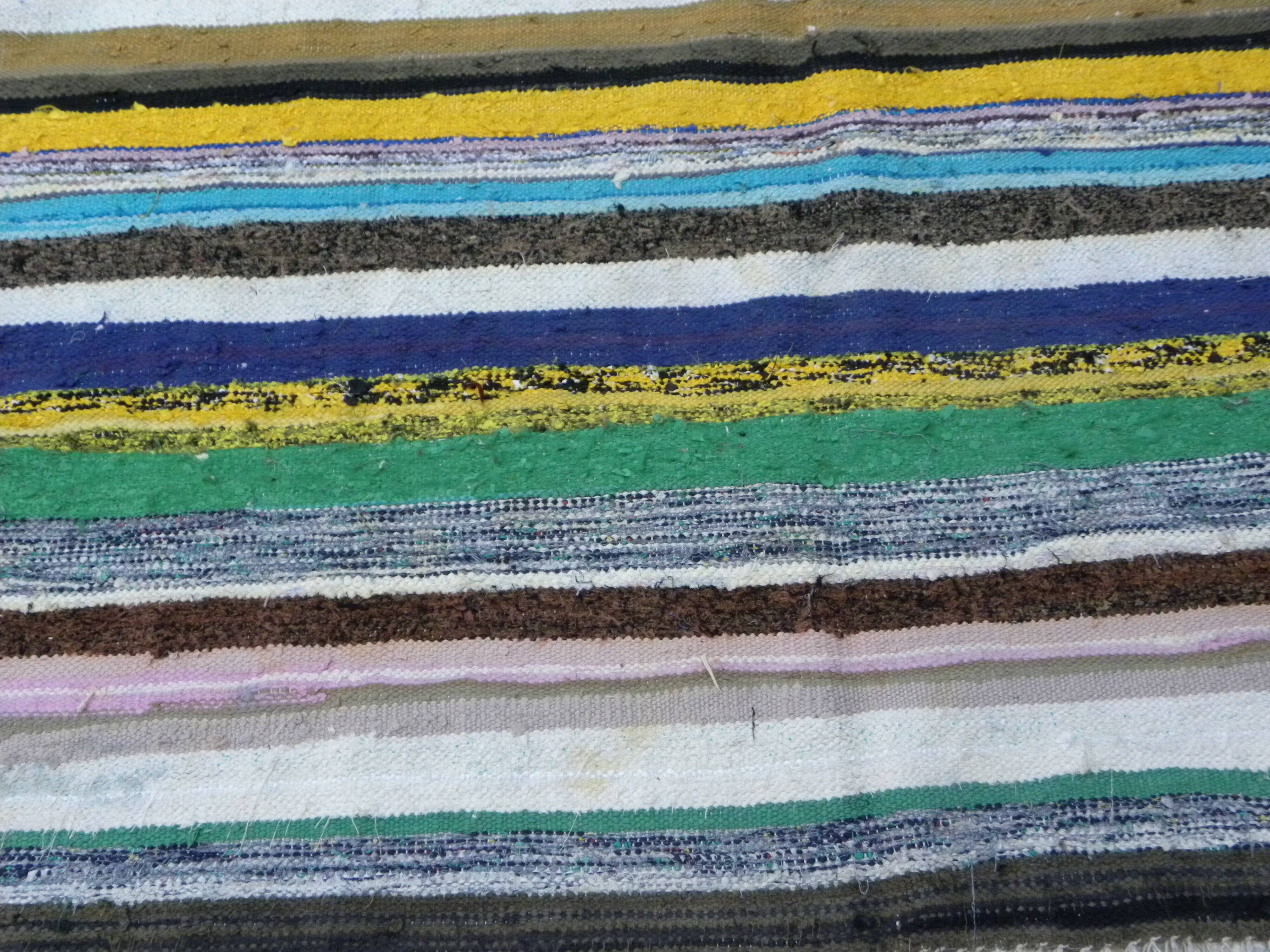 Vintage traditional nomadic kilim ethnic rug with multicoloured stripes.