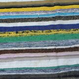 Vintage traditional nomadic kilim ethnic rug with multicoloured stripes.