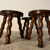 Wooden tripod stool with twisted legs