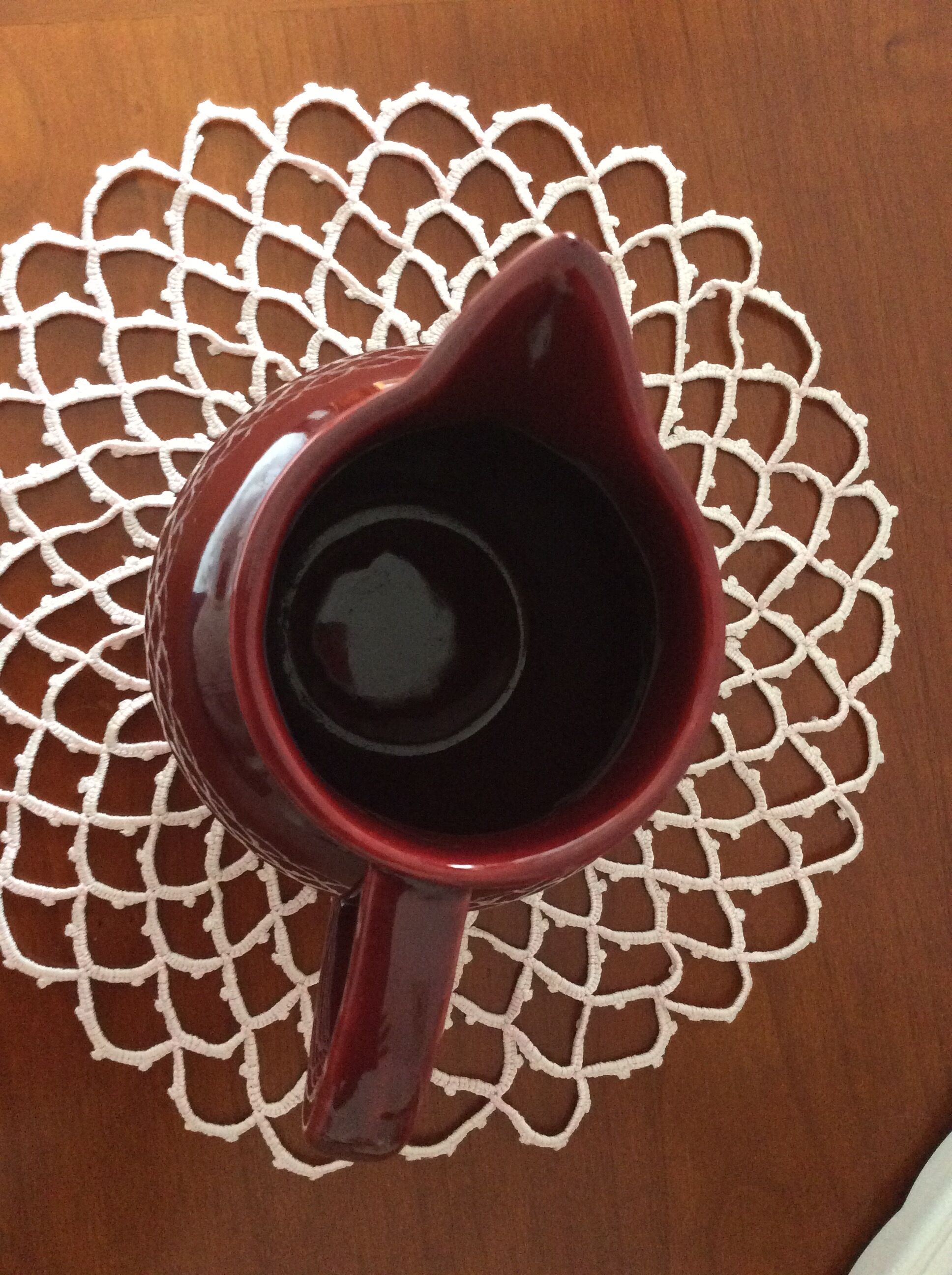 Old dark red ceramic pitcher jug