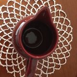 Old dark red ceramic pitcher jug