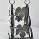 Vintage black wrought iron bottle holder decorated with vine leaves