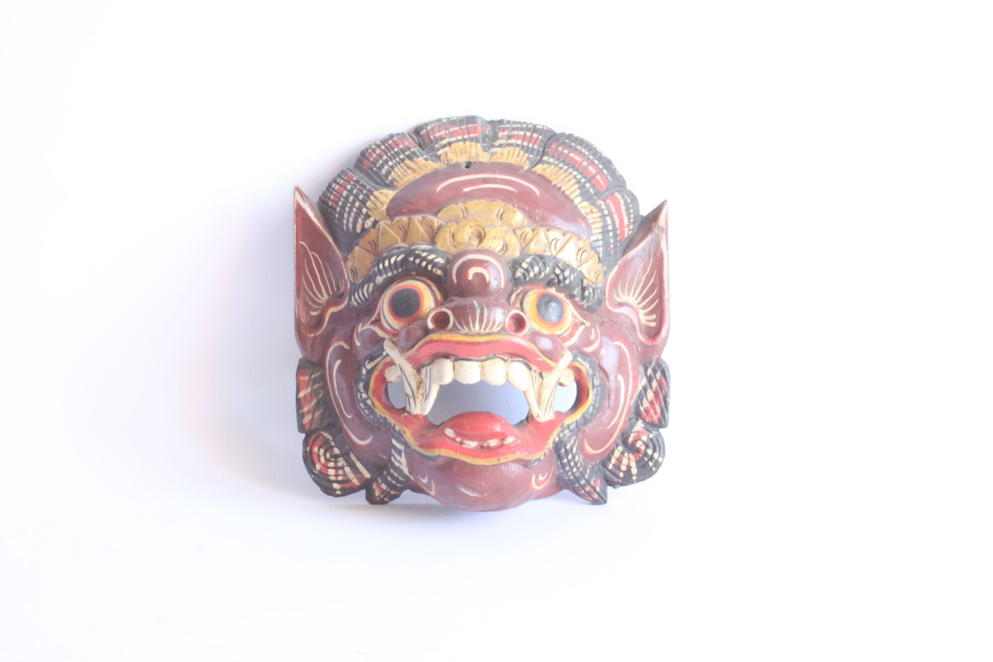 Two polychrome painted and gold leaf gilded Barong dance masks from Bali, Indonesia.