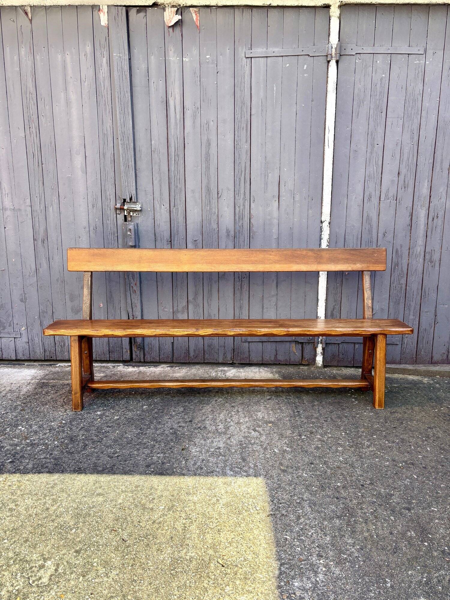 Brutalist bench with dark wood back