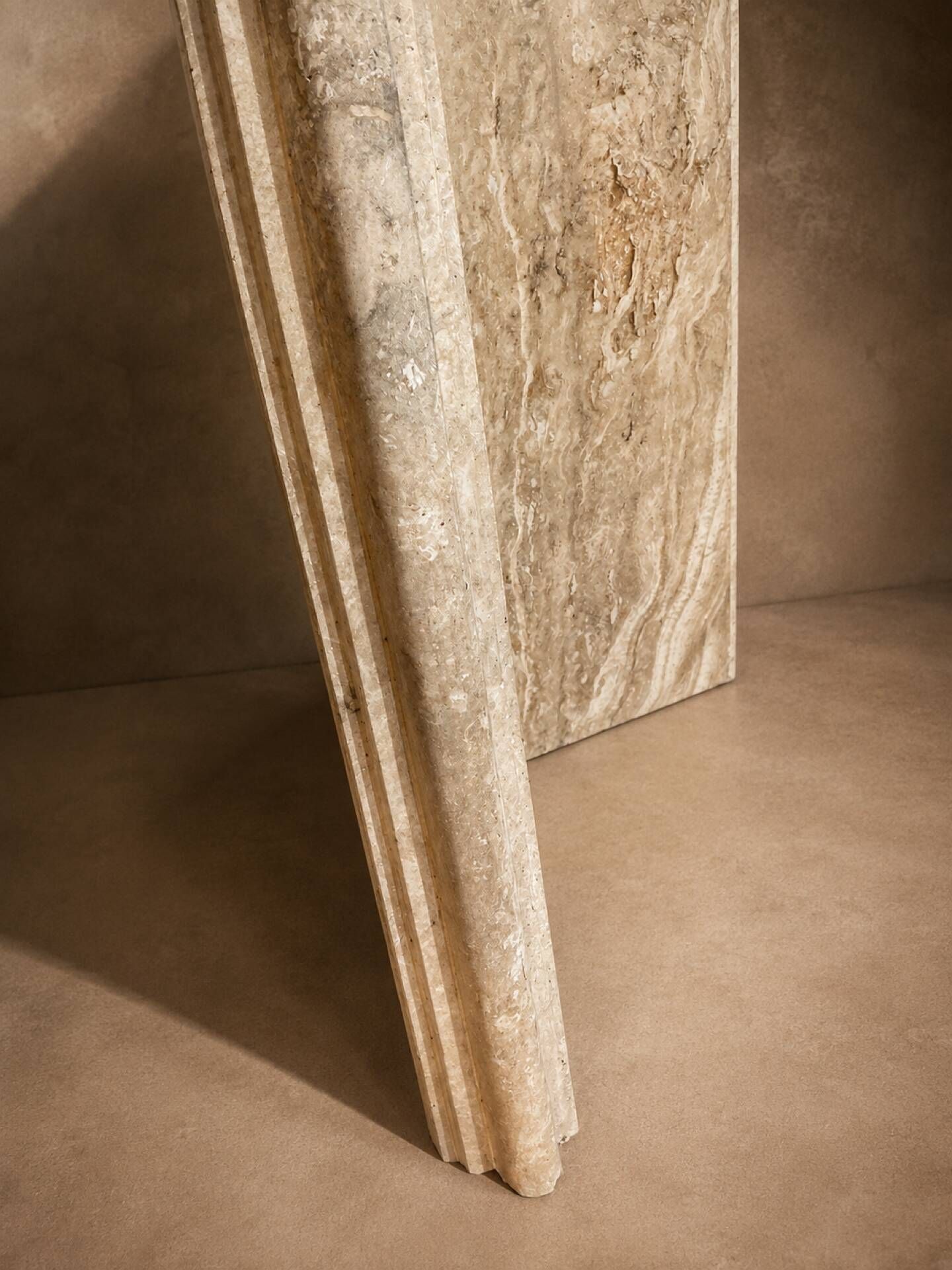 Dining table in travertine and smoked glass.