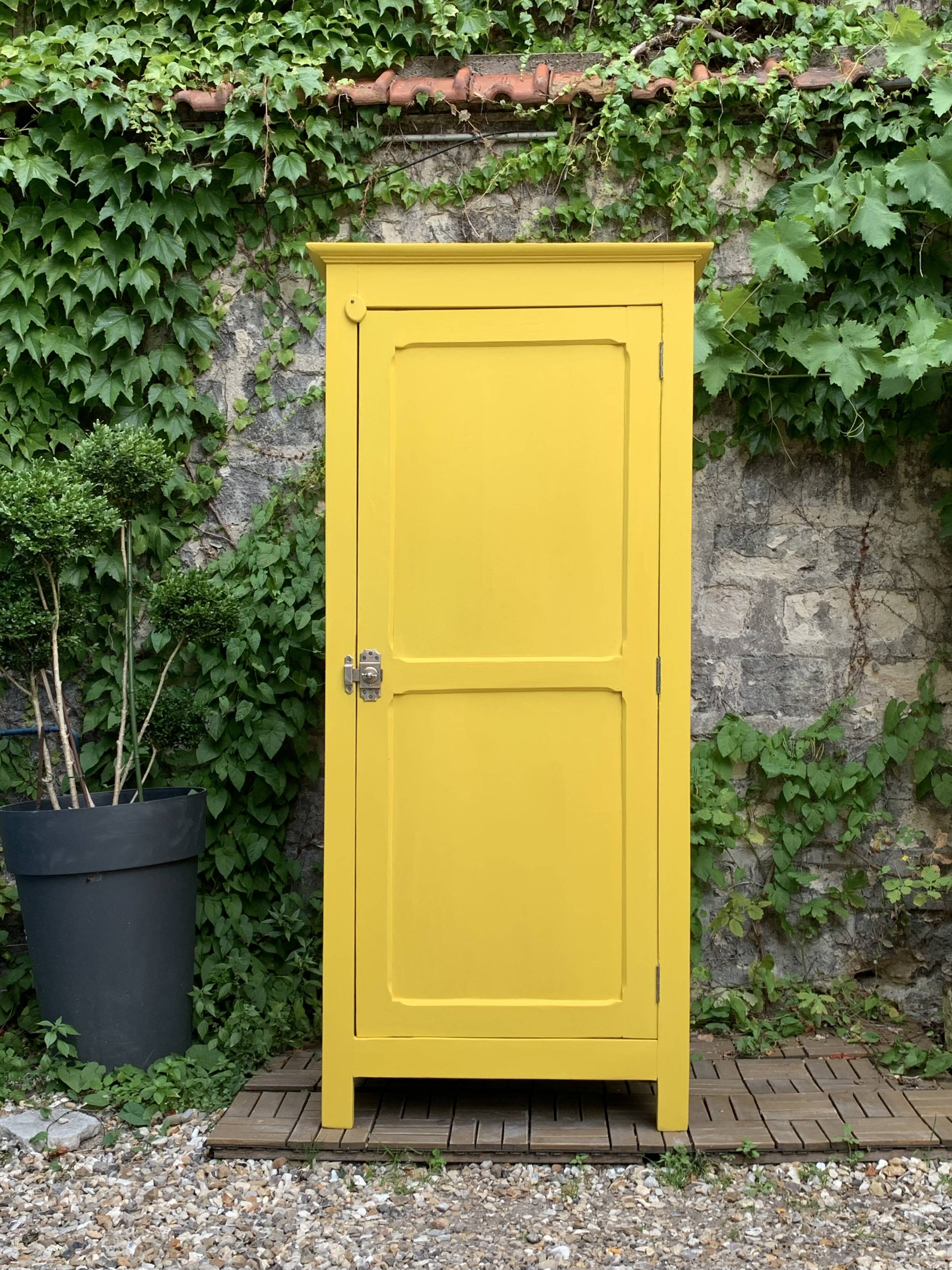 Antique powder yellow Parisian bonnetière wardrobe.