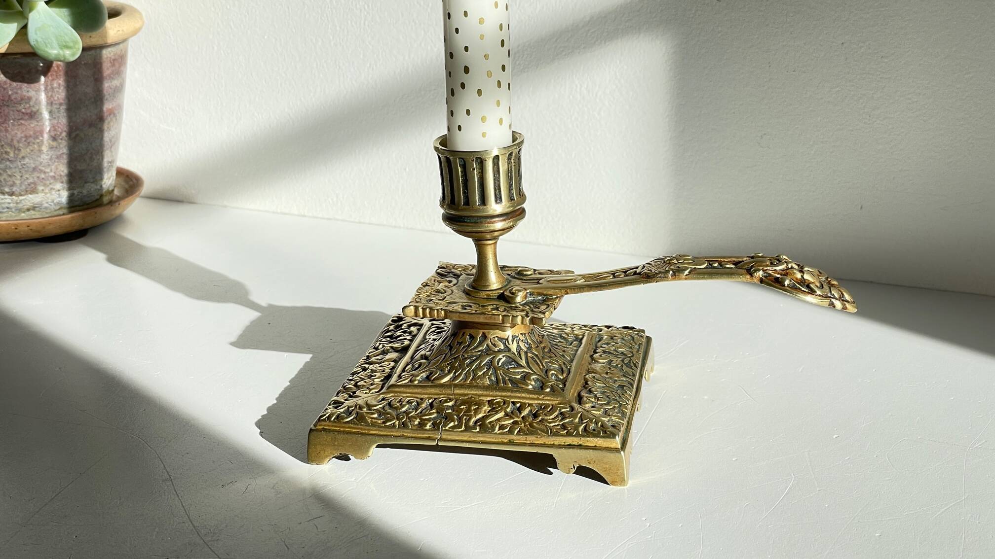 Patterned solid bronze hand candle holder