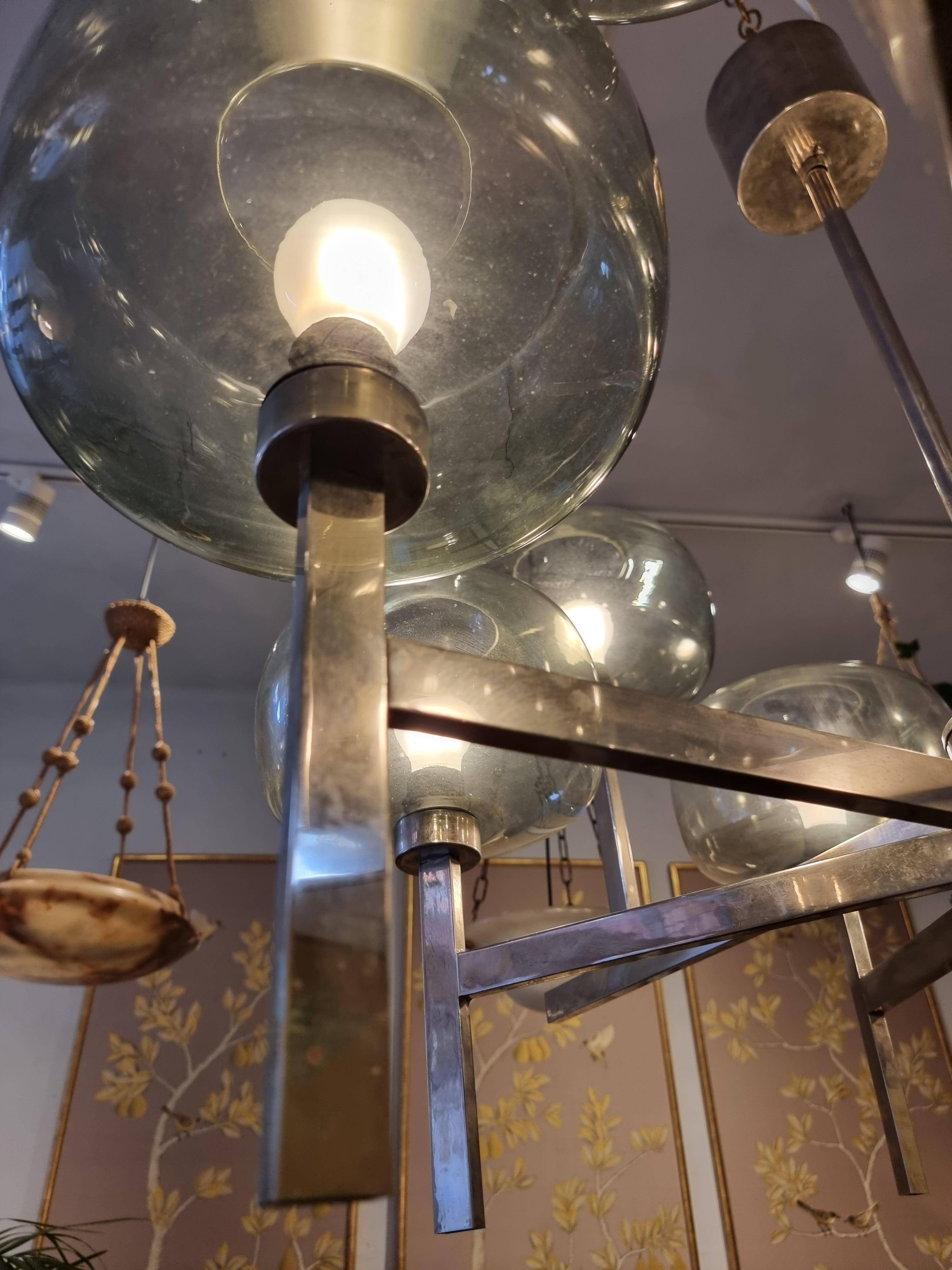 Timeless modern Scandinavian / mid-century chandelier in chrome and smoked glass.