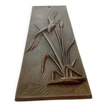 Metal table with zoomorphic bird.