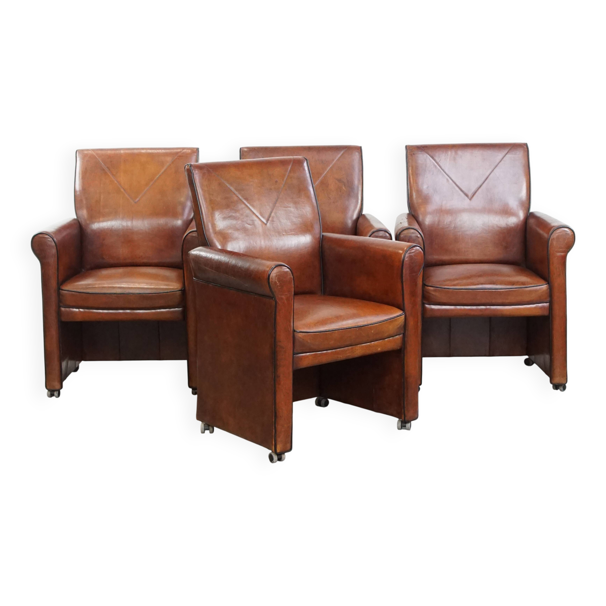 Vintage set of 4 sheepskin leather dining chairs on castors