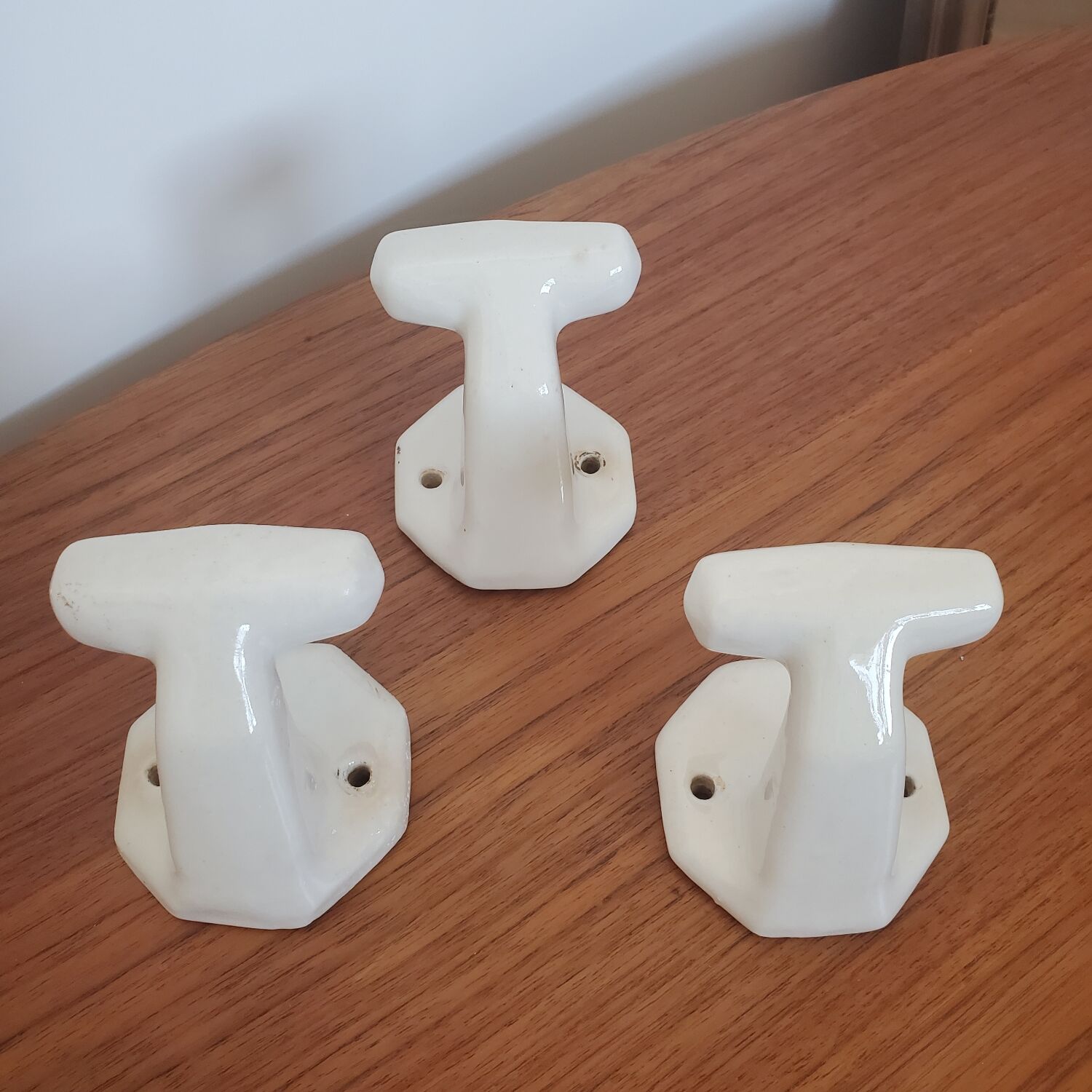 Trio of white porcelain hooks