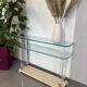 Hollywood Regency console style in travertine, glass, and Lucite.
