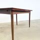 Rosewood dining table with integrated extensions — Denmark, 1960s