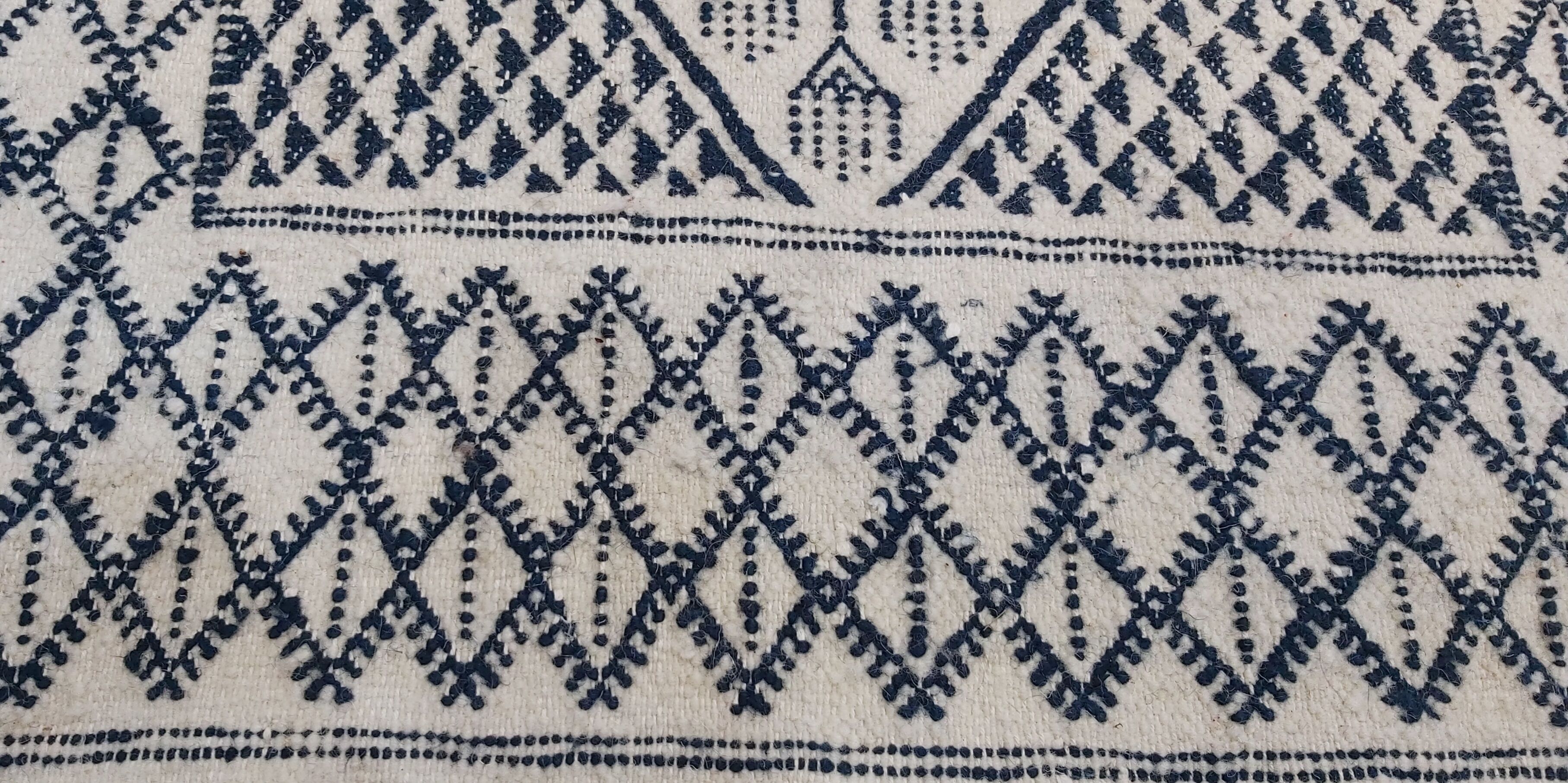Traditional white and blue hand-woven wool carpet